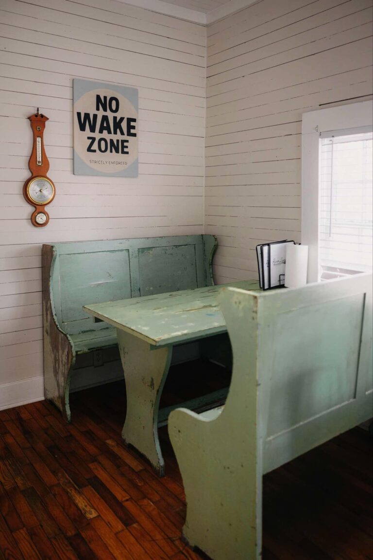 Booth seating beneath a No Wake Zone sign inside River Landing Coffee Co.