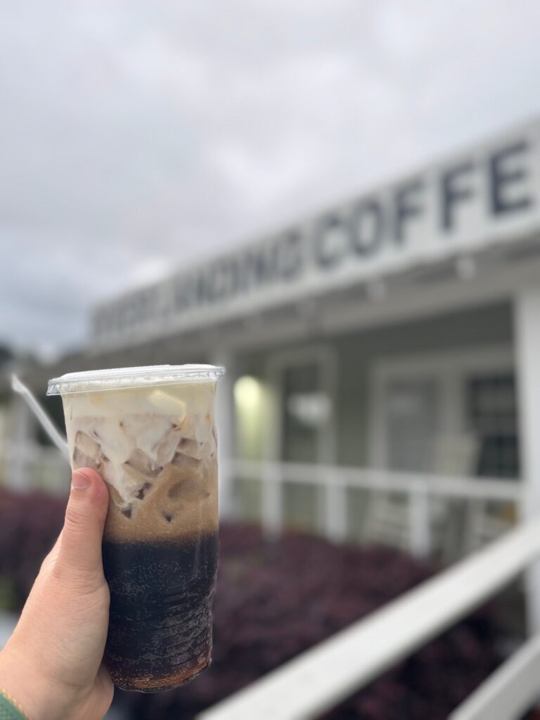 Dirty soda held up by the front porch of River Landing Coffee Co.
