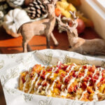 Duck Blind Flatbread with eggs, cheese and bacon in a River Landing paper-lined tray