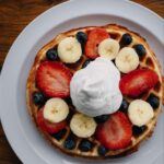 Loaded waffle topped with berries and bananas