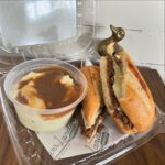 Pot roast sandwich with a side of mashed potatoes and gravy
