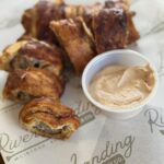 Swamp Bites with a cup of house-made cream cheese dip