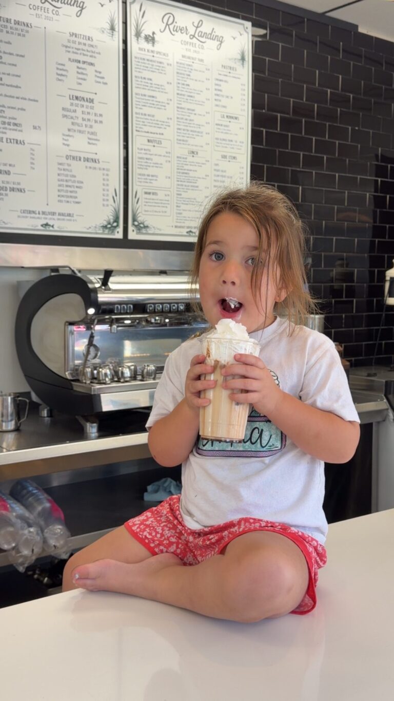 Young customer enjoying a whipped cream drink at the River Landing counter